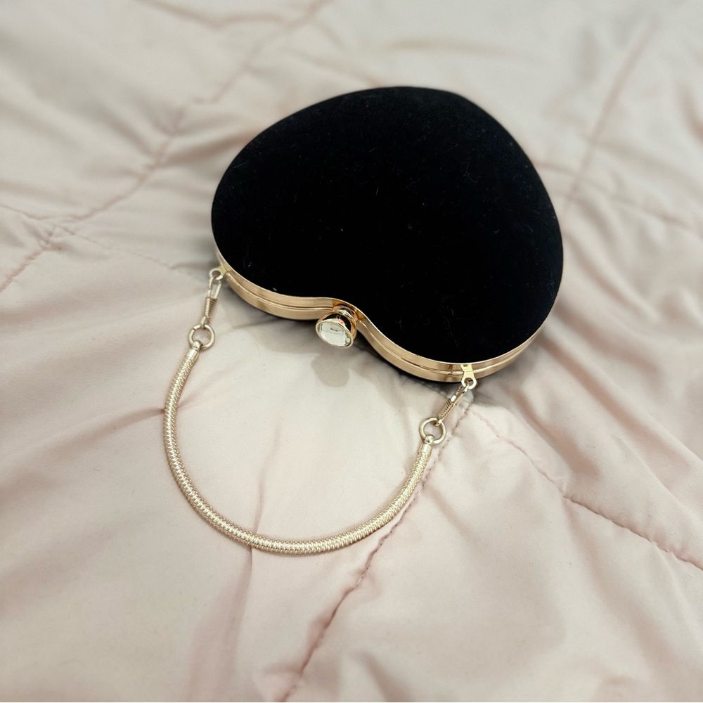 Heart-Shaped Black Clutch with Gold Trim